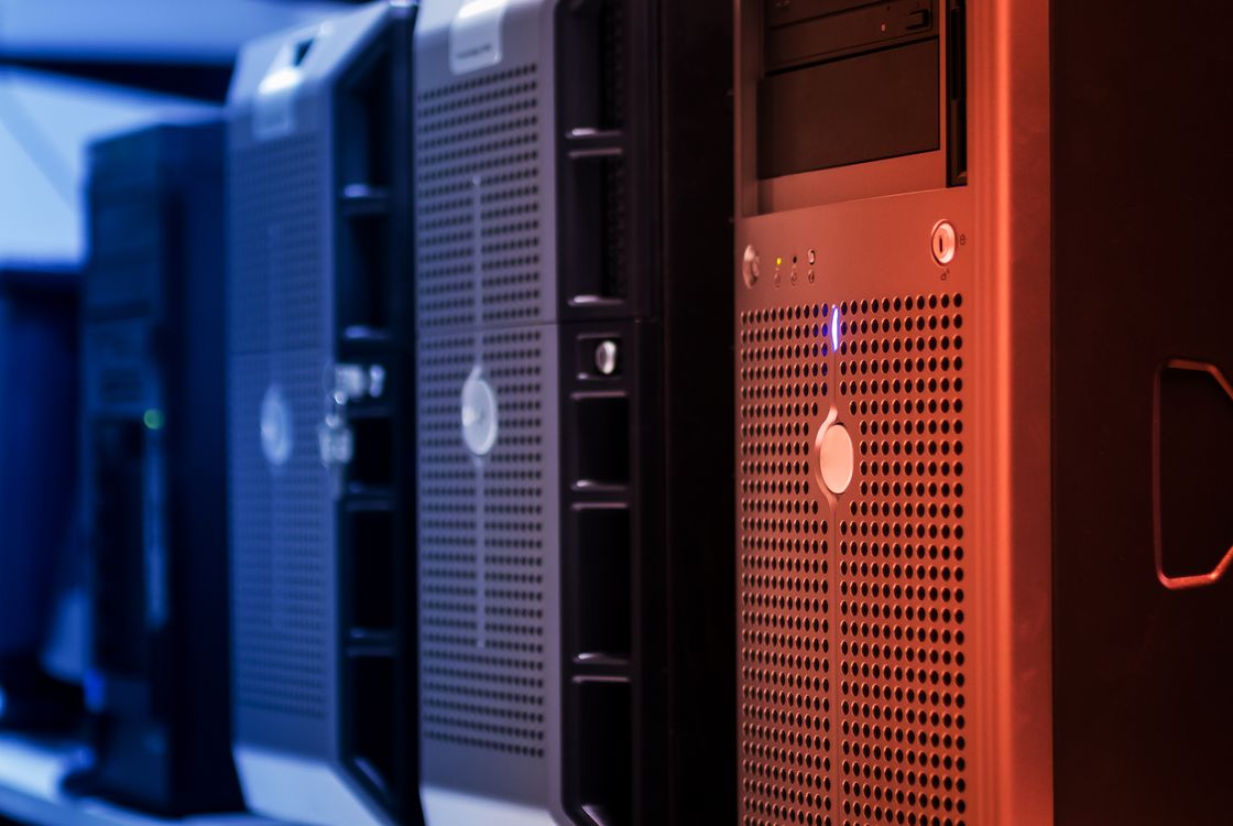 Close-up of tower servers in a data center with blue and red lighting