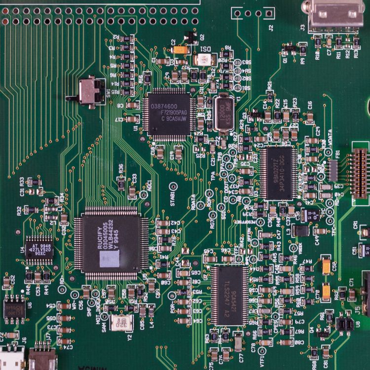 Close-up of a green circuit board with microprocessors and other components