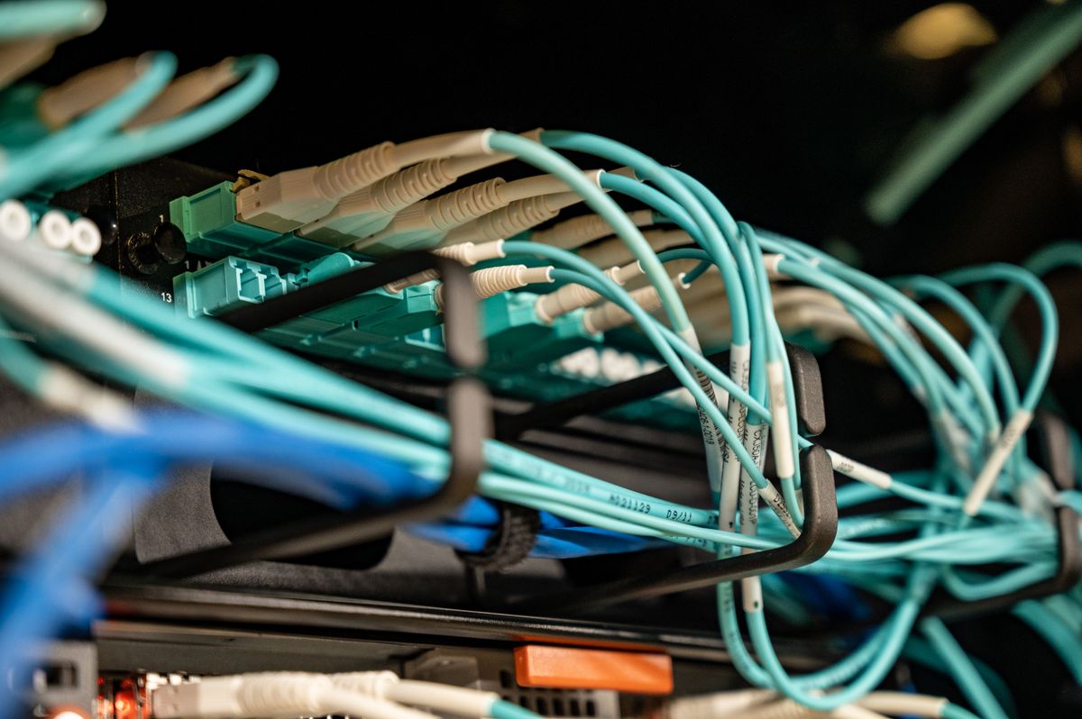 Close-up of fiber-optic cables plugged into a network switch patch panel