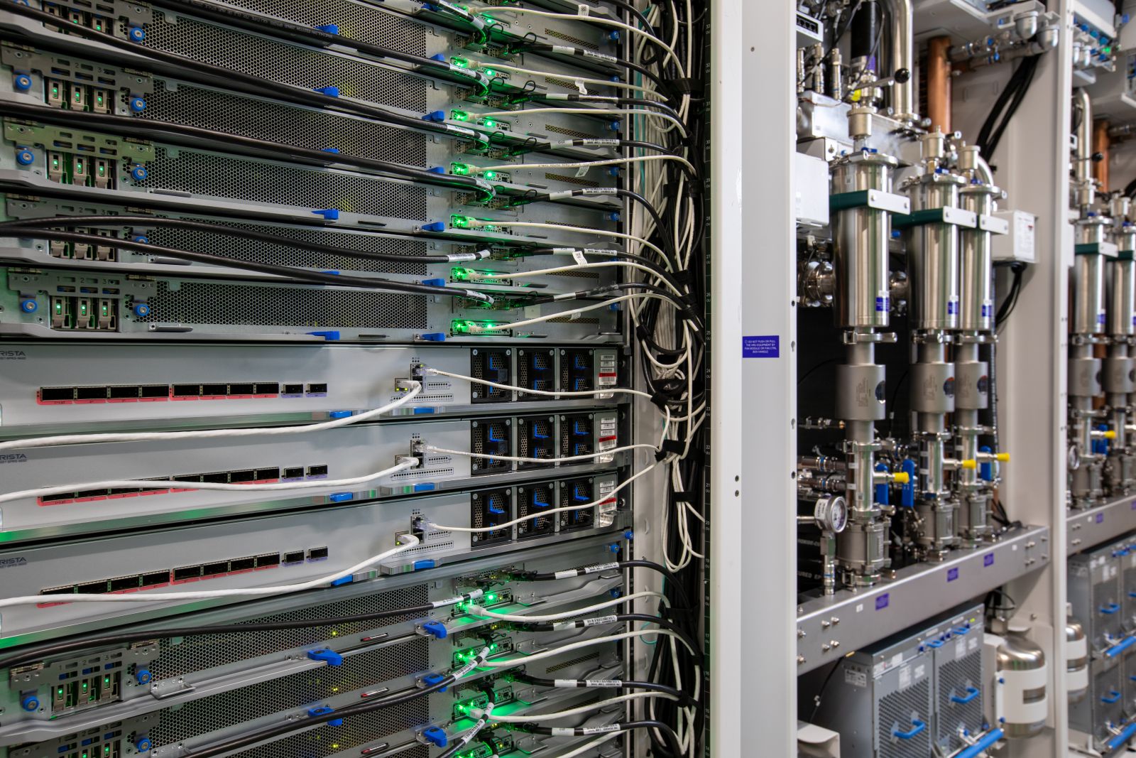 Server racks with connected cables and green indicator lights in a Microsoft datacenter
