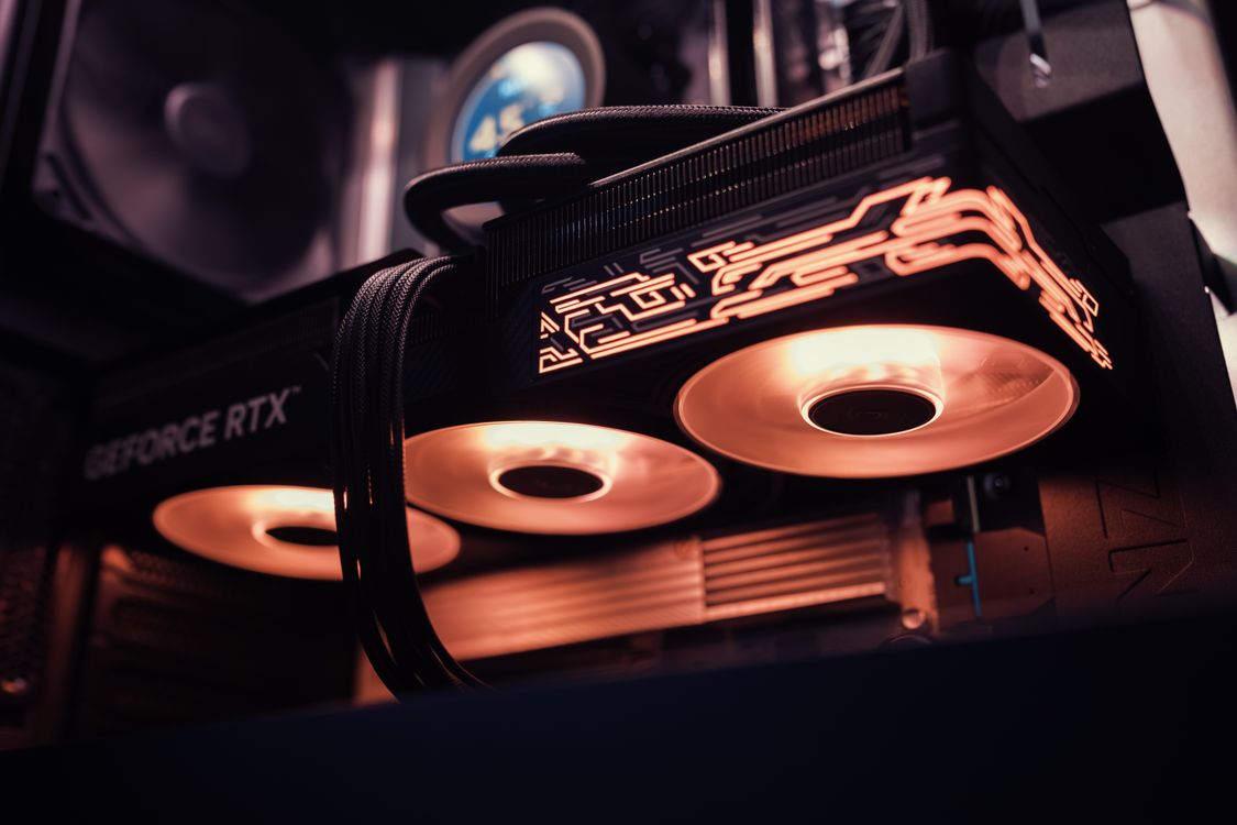 Close-up of a GeForce RTX GPU with glowing LED lights inside a computer case