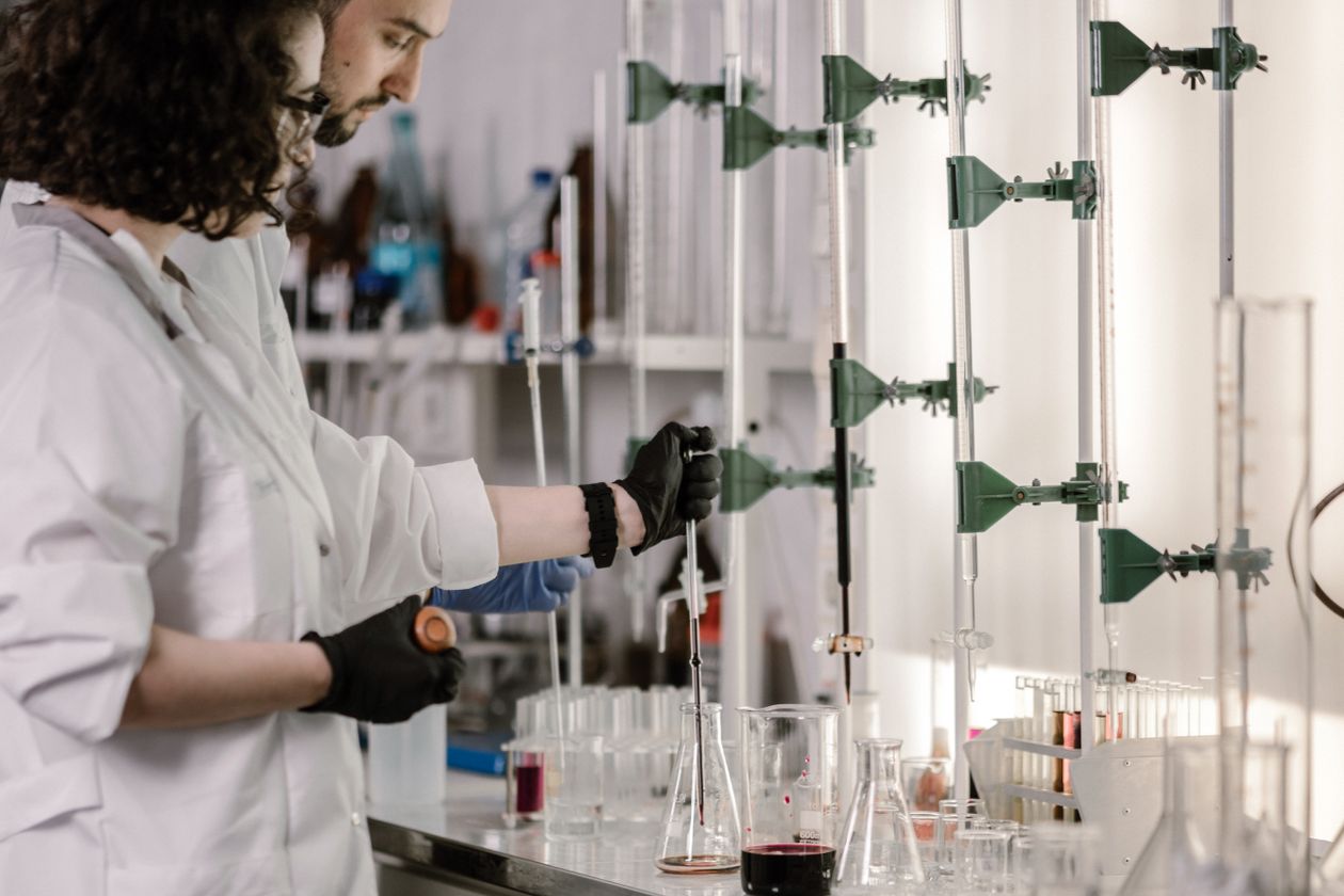 Scientists in lab coats working with test tubes in a modern laboratory