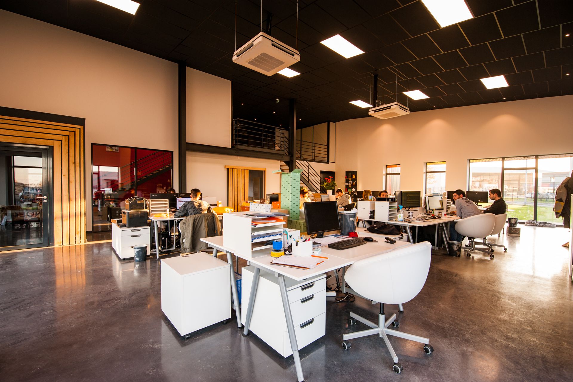 People working at computers in a modern open-plan small-business office