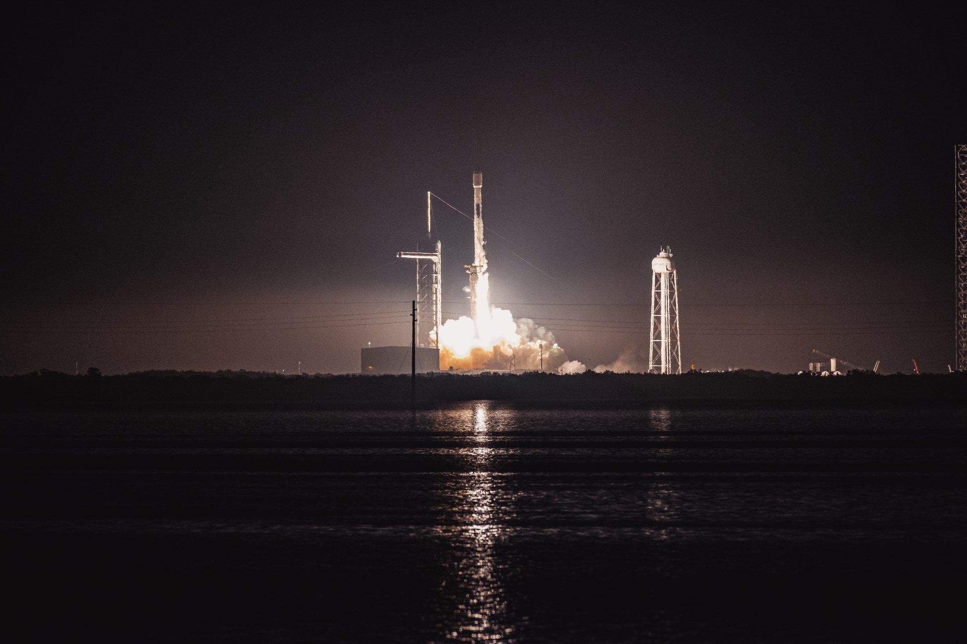 A SpaceX Falcon 9 rocket lifts off at night from Launch Complex 39A at Kennedy Space Center