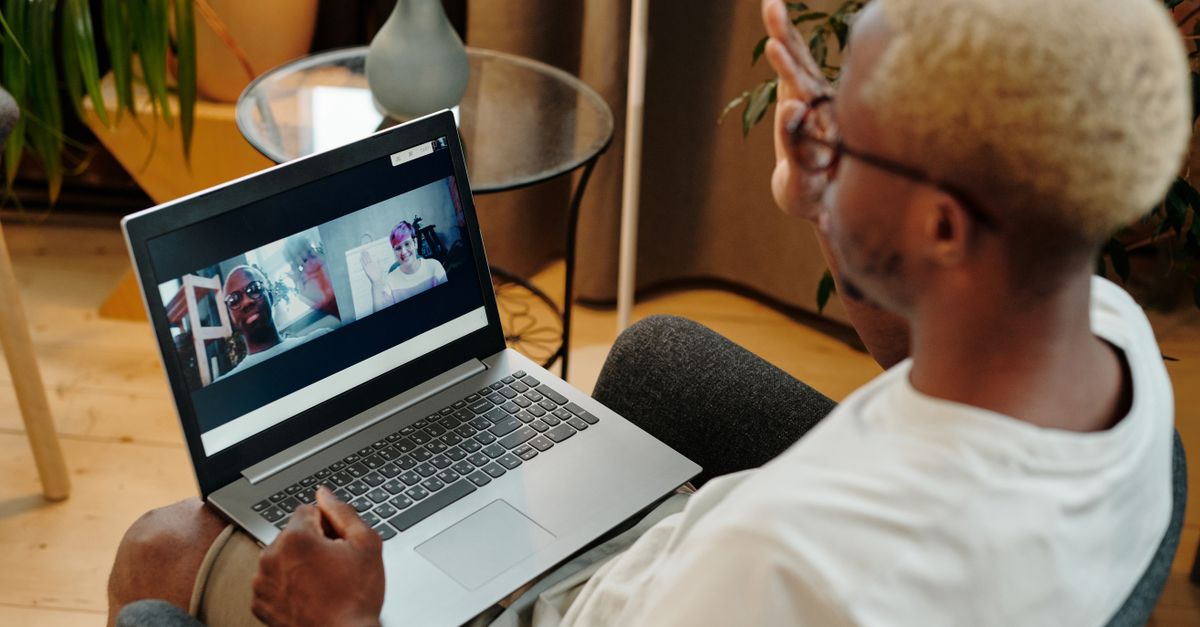 A person joining a video call on a laptop
